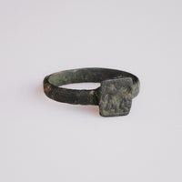 Front view of Byzantine bronze ring Zosimos showing raised square bezel and animal motif
