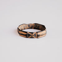 Front view of medieval bronze ring Aldric with dark tenorite patina in incised grooves