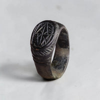 Front view of medieval bronze ring Vespasia showing octagram device and hatched shoulder engraving
