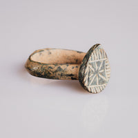 Front view of medieval bronze ring Zvezdan showing star-in-square bezel with hatched border