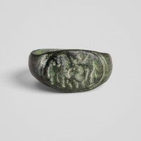 Front view of Roman bronze ring Equirius with mounted rider and flanking figures in relief