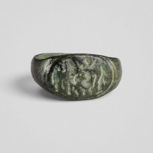 Front view of Roman bronze ring Equirius with mounted rider and flanking figures in relief