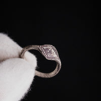 Held medieval silver signet ring Ruslan showing bezel detail and central worn motif
