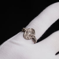 Roman silver ring Veneria shown on a gloved finger, engraved plate facing the camera