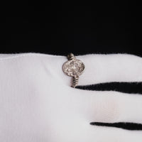 Roman silver ring Veneria on a gloved finger, seen from above with the engraved oval plate
