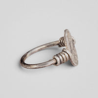Side view of Roman silver ring Veneria showing the plate edge, coiled wire loops and round-section hoop