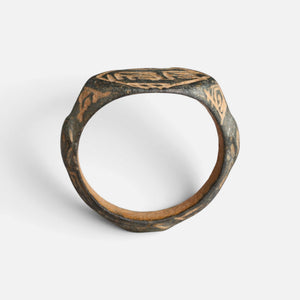 Medieval Islamic bronze ring 'Nasirun' shows its full hoop and the edge of its engraved bezel in profile.
