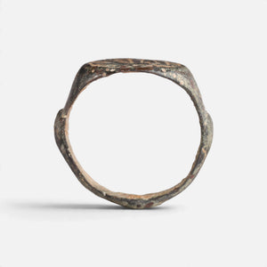 Medieval Islamic bronze ring 'Tahir' shows its full hoop and the broad round bezel edge in profile.