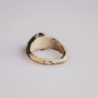Interior view of Roman bone ring Numerius showing cream bone surface