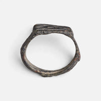 Roman bronze ring 'Lucina' shows its full hoop and the flat rectangular bezel edge in profile.