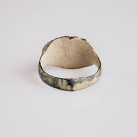 Interior view of Roman bronze ring Numerius showing calcareous encrustation and bezel underside