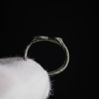 Interior view of Roman bronze ring Numerius showing hoop profile and wear patina