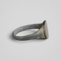 Low side view of medieval bronze ring Lioris highlighting trumpet-form shoulders
