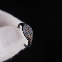 Macro close-up of the engraved ant motif on Roman bronze signet ring Formica