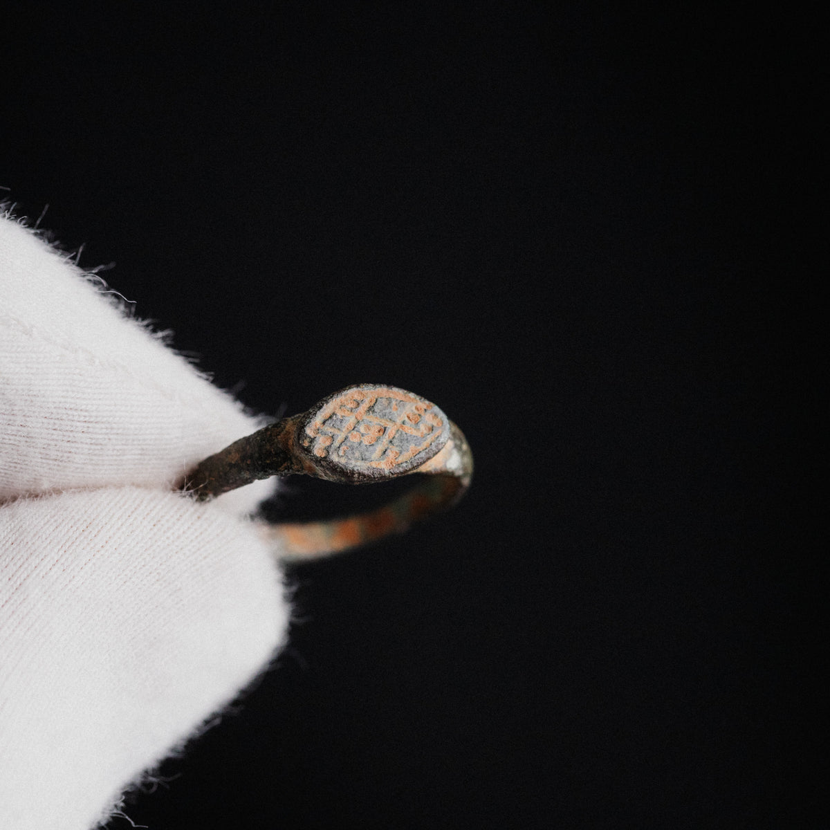 Macro detail of Byzantine bronze ring 'Theodora' bezel engraving with cross motif