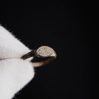 Macro detail of Byzantine bronze ring 'Theodora' bezel engraving with cross motif