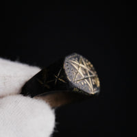 Macro detail of medieval bronze ring Astariel pentagram bezel and central dot