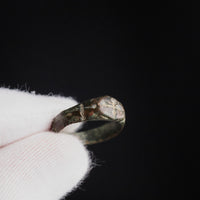Macro detail of medieval bronze ring Radenko showing incised crosses and worn surface.