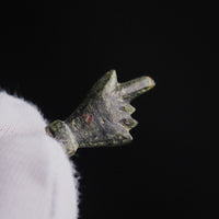 Macro detail of Roman bronze hand amulet Manicula, patina and modelling of knuckles