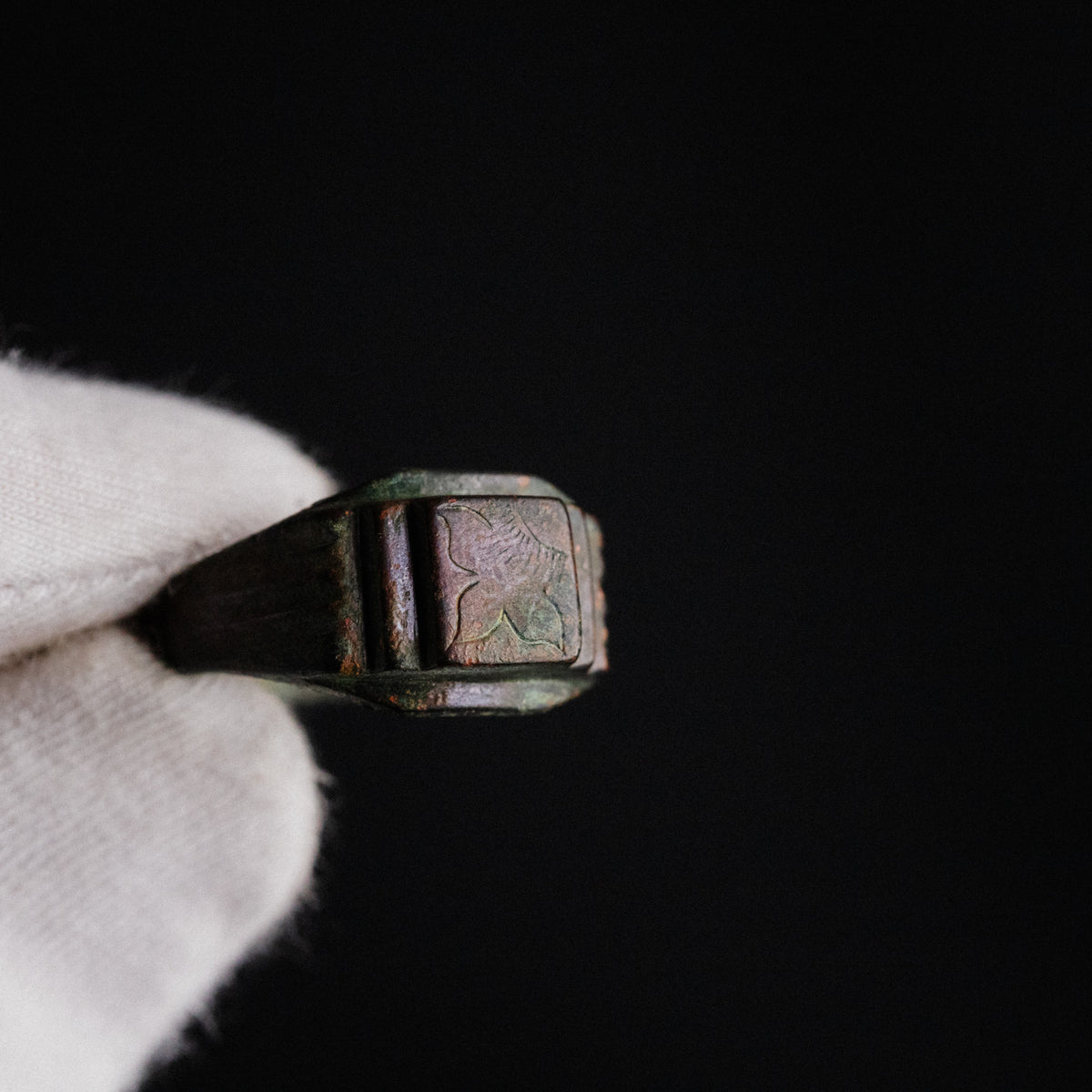 Macro view of Byzantine bronze ring Aetheria bezel engraving and cuprite patina