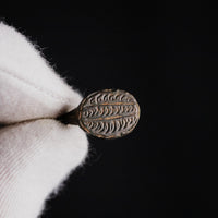 Macro view of Byzantine bronze ring Theodoros bezel with herringbone fern-frond motif