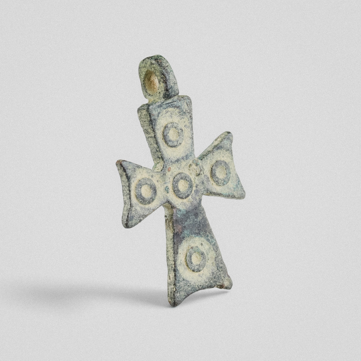 Byzantine bronze cross pendant 'Okellos' angled view showing cast suspension loop and relief bosses