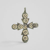 Medieval bronze cross pendant 'Rotunda' with nine ring-and-dot ornaments across budded arms, obverse view