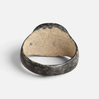 Medieval bronze ring 'Aldebrand' shows the plain back of its round bezel and the inner hoop.