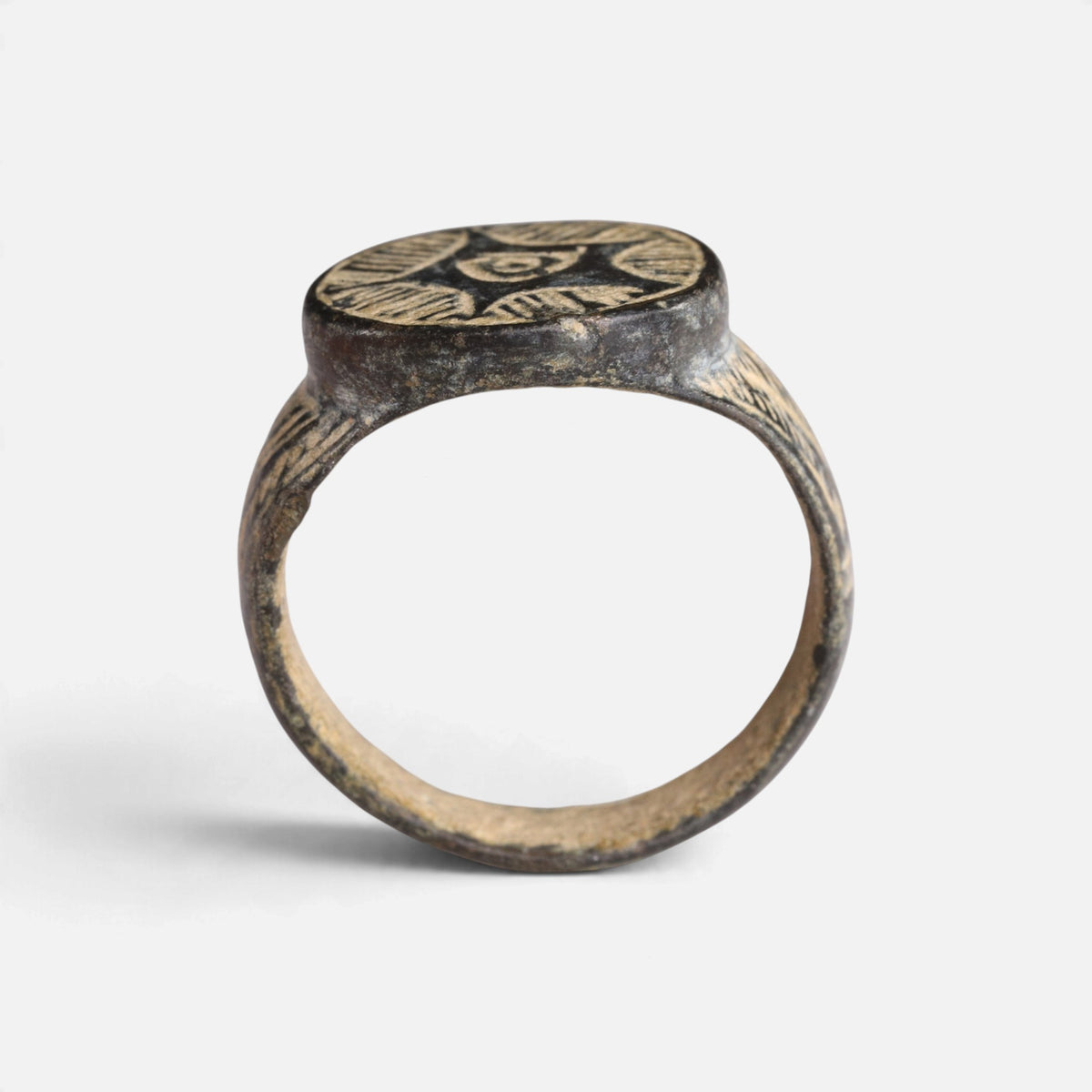 Medieval bronze ring 'Aldebrand' shows its complete hoop and the broad round bezel edge in profile.