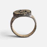 Medieval bronze ring 'Aldebrand' shows its complete hoop and the broad round bezel edge in profile.