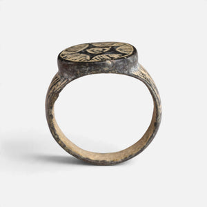 Medieval bronze ring 'Aldebrand' shows its complete hoop and the broad round bezel edge in profile.
