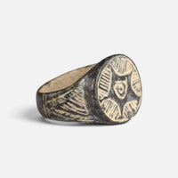 Medieval bronze ring 'Aldebrand' shows its circular geometric bezel and engraved broad shoulder at an angle.