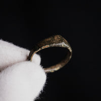 Medieval bronze ring Alderic close-up on gloved hand showing inner hoop patina