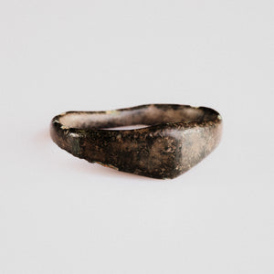 Medieval bronze ring Alderic shown from the front, revealing the tapering D-profile band