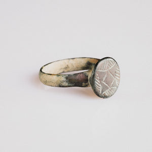 Medieval bronze ring 'Aldric' front view showing raised circular bezel and hatched geometric device