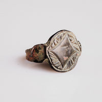 Medieval bronze ring Aldwyn showing circular bezel and scratch-work spandrels