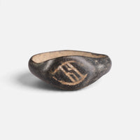 Medieval bronze ring 'Arnulf' shows the angular incised device on its pointed oval bezel from the front.
