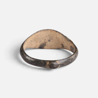 Medieval bronze ring 'Arnulf' shows the plain back of its bezel and the inside of its hoop.