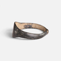 Medieval bronze ring 'Arnulf' shows its broad shoulder and bezel edge from the opposite side.