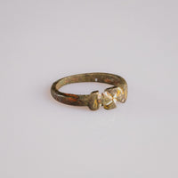 Medieval bronze ring Cruciata showing cross pattée and rounded shoulders in three-quarter view
