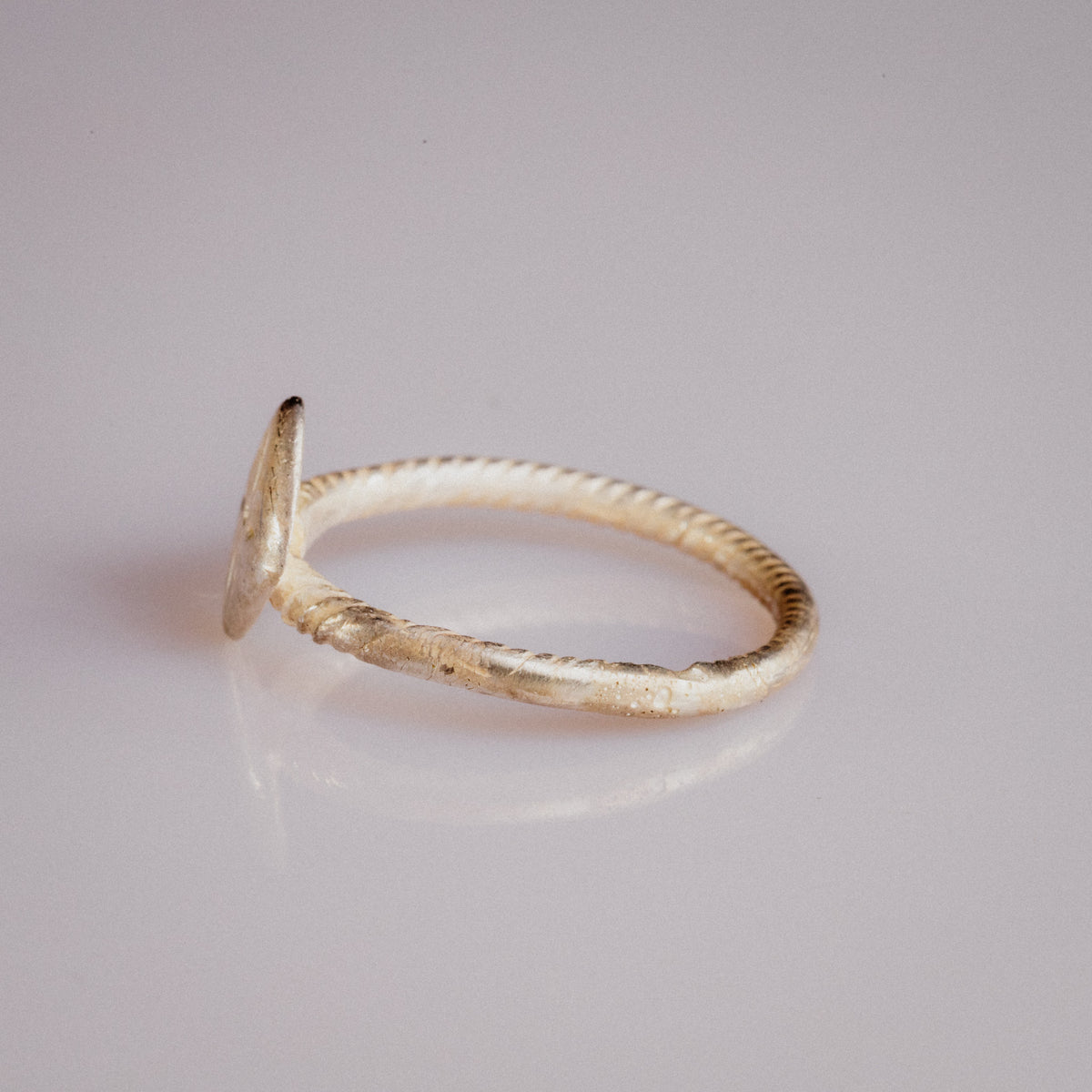 Medieval bronze ring Florentia inner hoop view revealing cable pattern and age-related surface