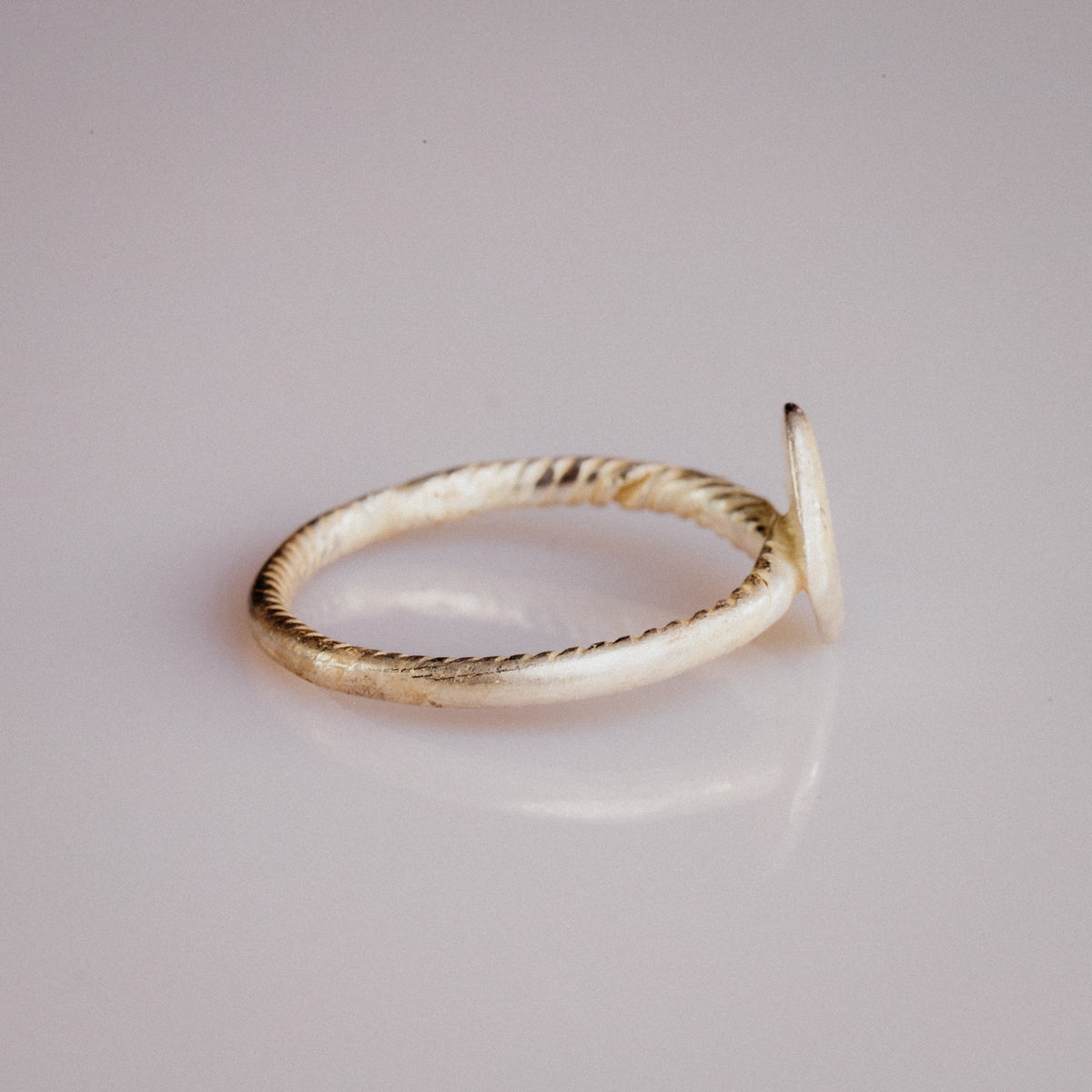 Medieval bronze ring Florentia side profile showing twisted-wire cable band construction