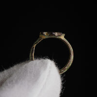 Medieval bronze ring Florian held in hand, profile view showing bezel height