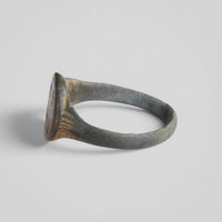 Medieval bronze ring Lioris tilted to reveal radiating grooves and worn patina