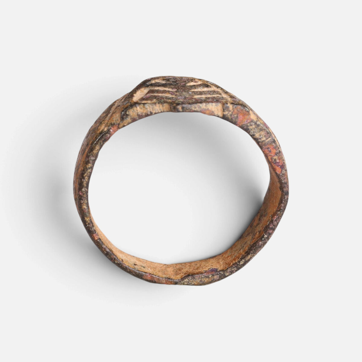 Medieval bronze ring 'Radbert' shows its decorated hoop and shield-shaped bezel edge in profile.