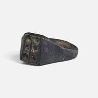 Medieval bronze ring 'Radomar' shows its six-recess bezel and hoop from the opposite front angle.