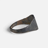 Medieval bronze ring 'Radomar' shows its broad inner shoulder and the back of its hoop at an angle.