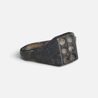 Medieval bronze ring 'Radomar' shows its six-recess bezel and broad shoulder at an angle.