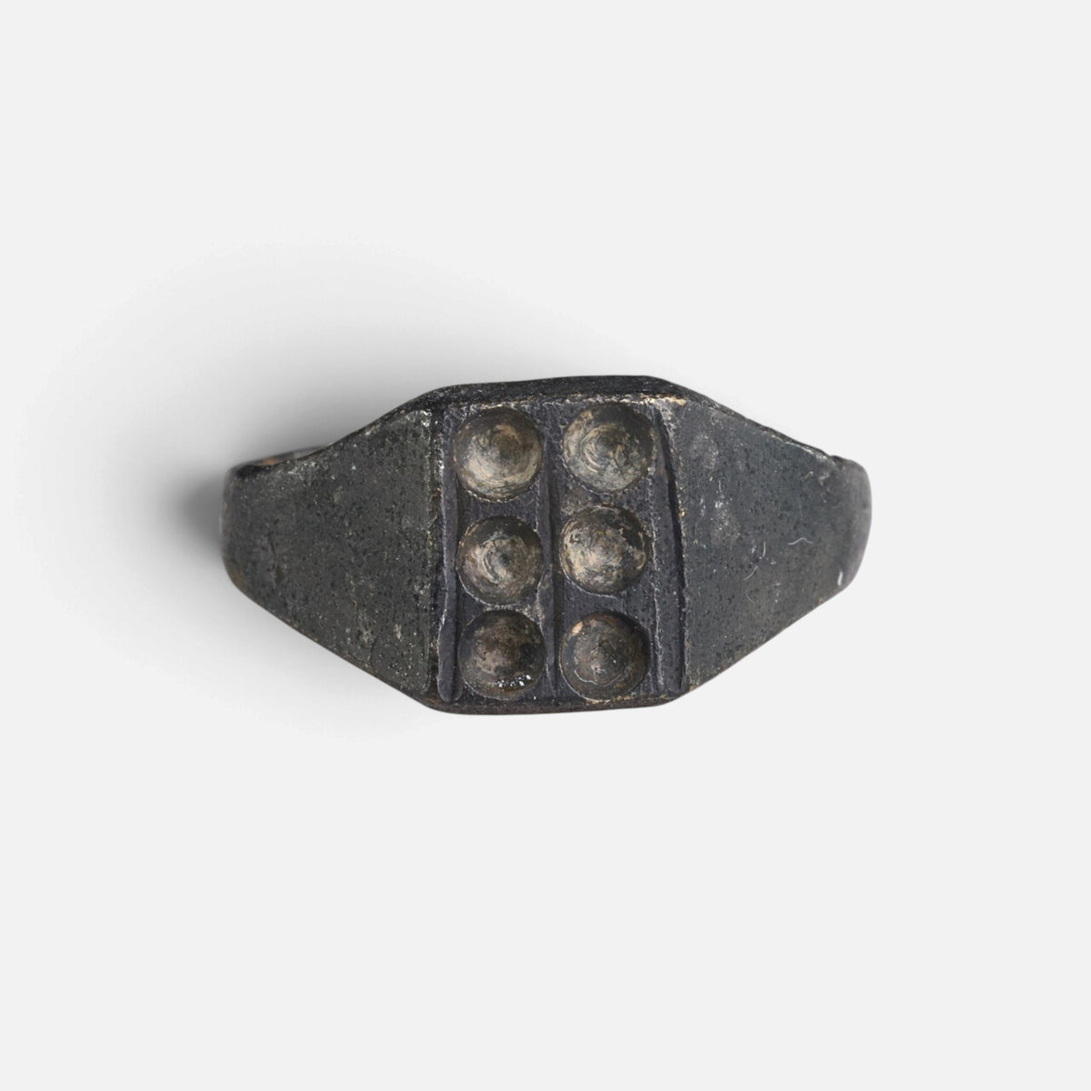 Medieval bronze ring 'Radomar' shows six circular recesses arranged in two columns on its bezel.