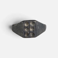 Medieval bronze ring 'Radomar' shows six circular recesses arranged in two columns on its bezel.